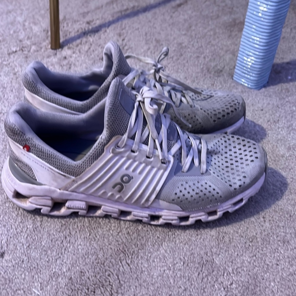 Grey on cloud running shoes.  There are 2 holes on the side of each shoe.